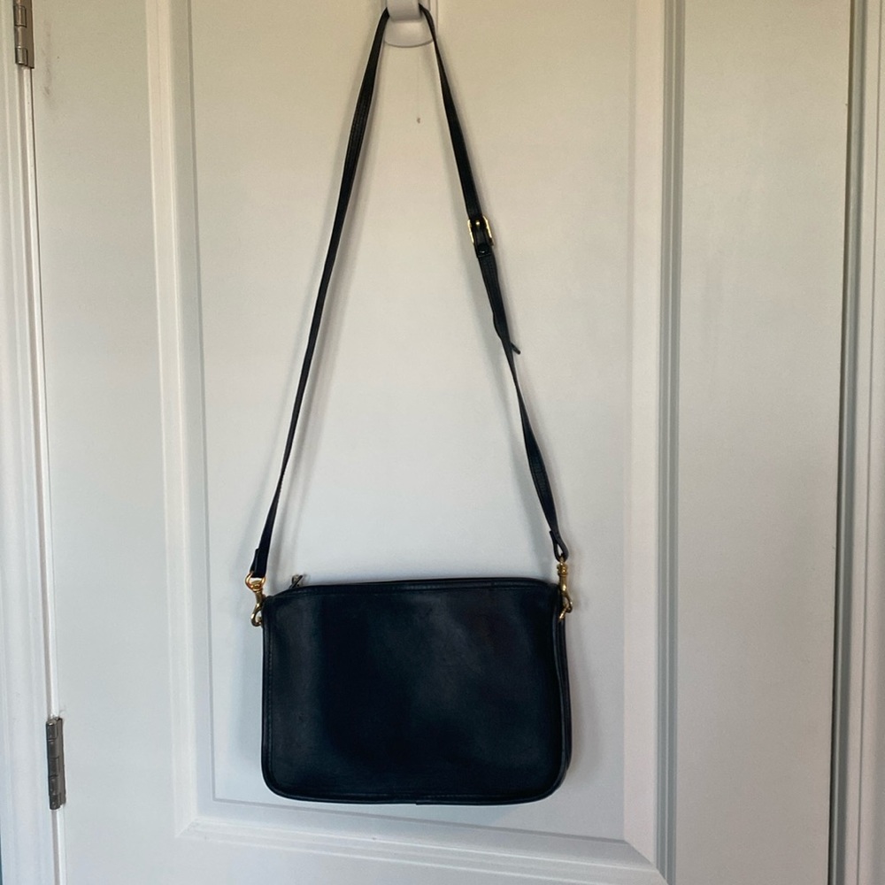 Black leather purse that can be worn, cross body or used with the shorter strap.